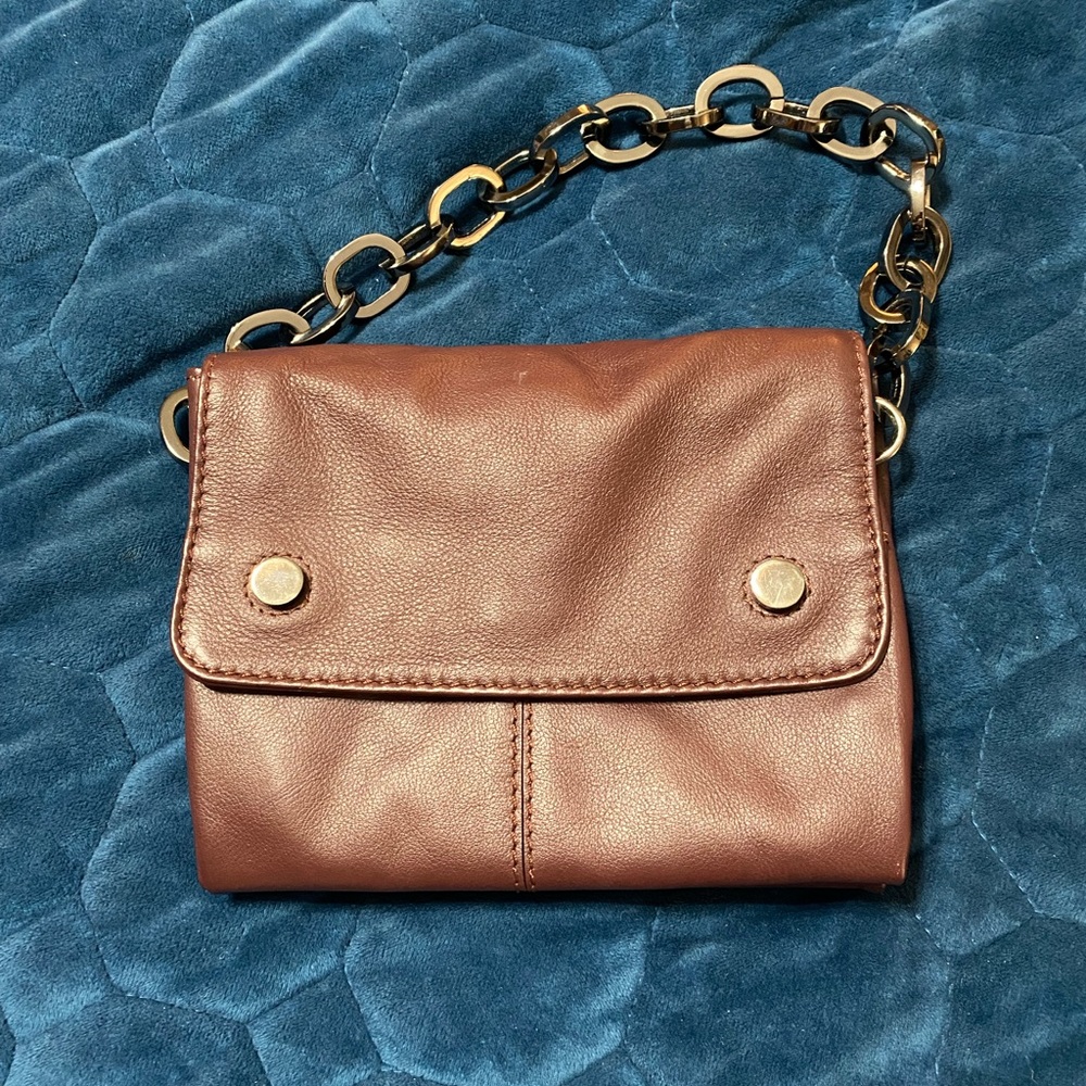 Rich dark burgundy leather bag with gray black metallic hardware. Small handbag
